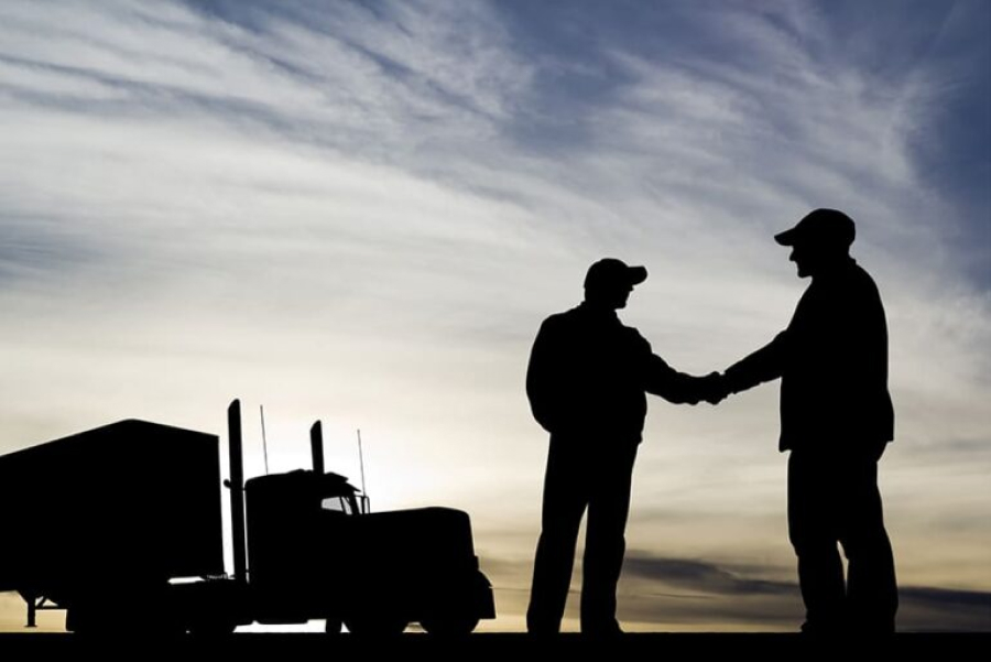 two truckers shaking hands